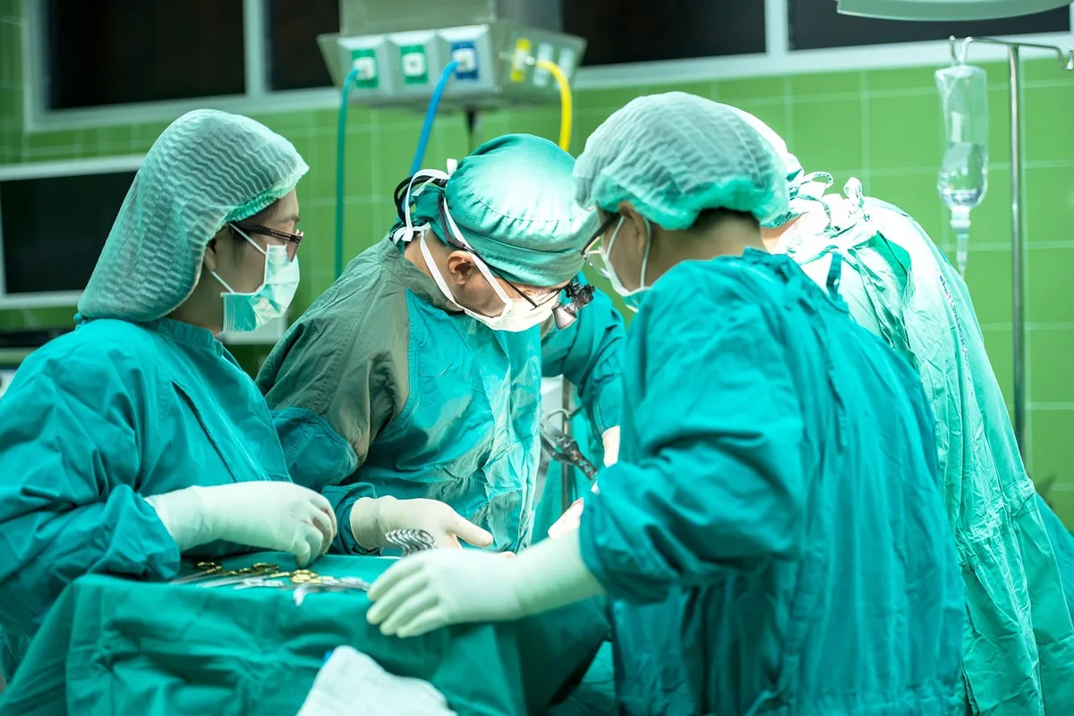 A nurse reviewing a patient file and preparing bandage supplies on a clean counter